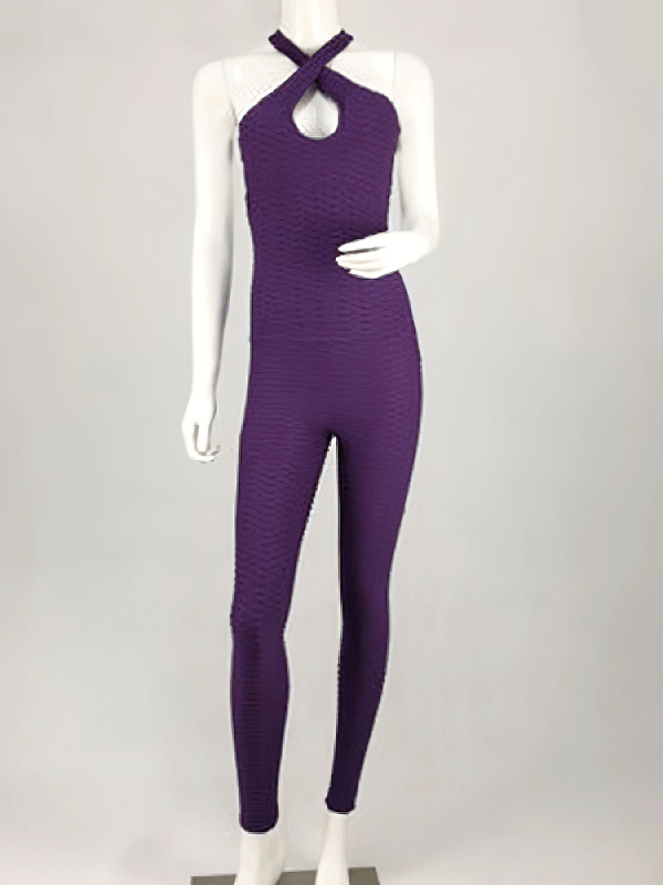 Women's textured open-back yoga jumpsuit in purple displayed on a mannequin, showcasing breathable nylon material and sleek design for comfort.